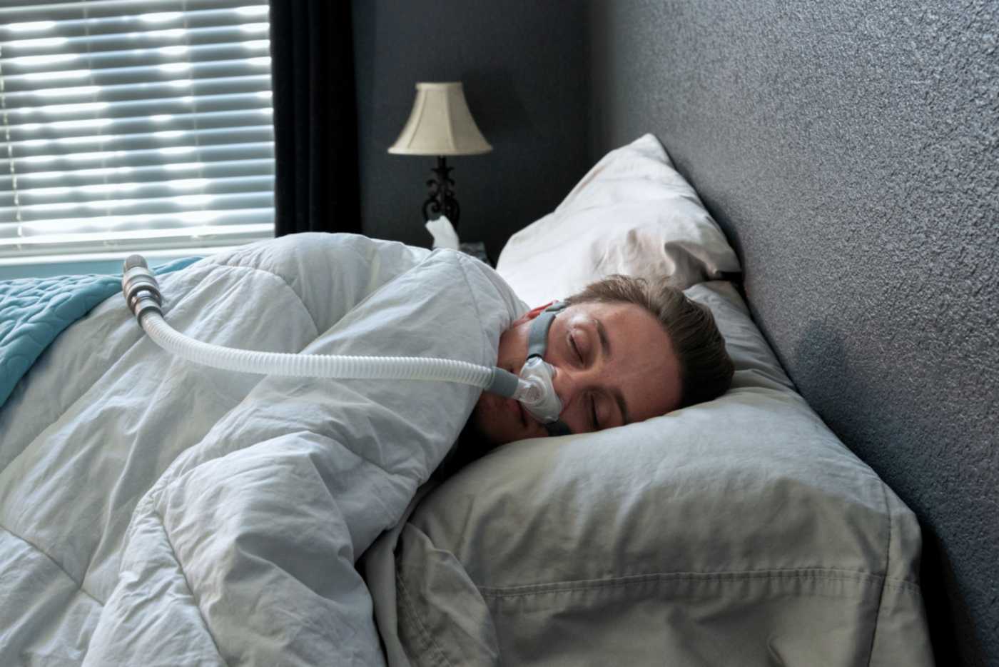A young man sleeps with a CPAP machine A young man sleeps with a CPAP machine in Bonita Springs, FL